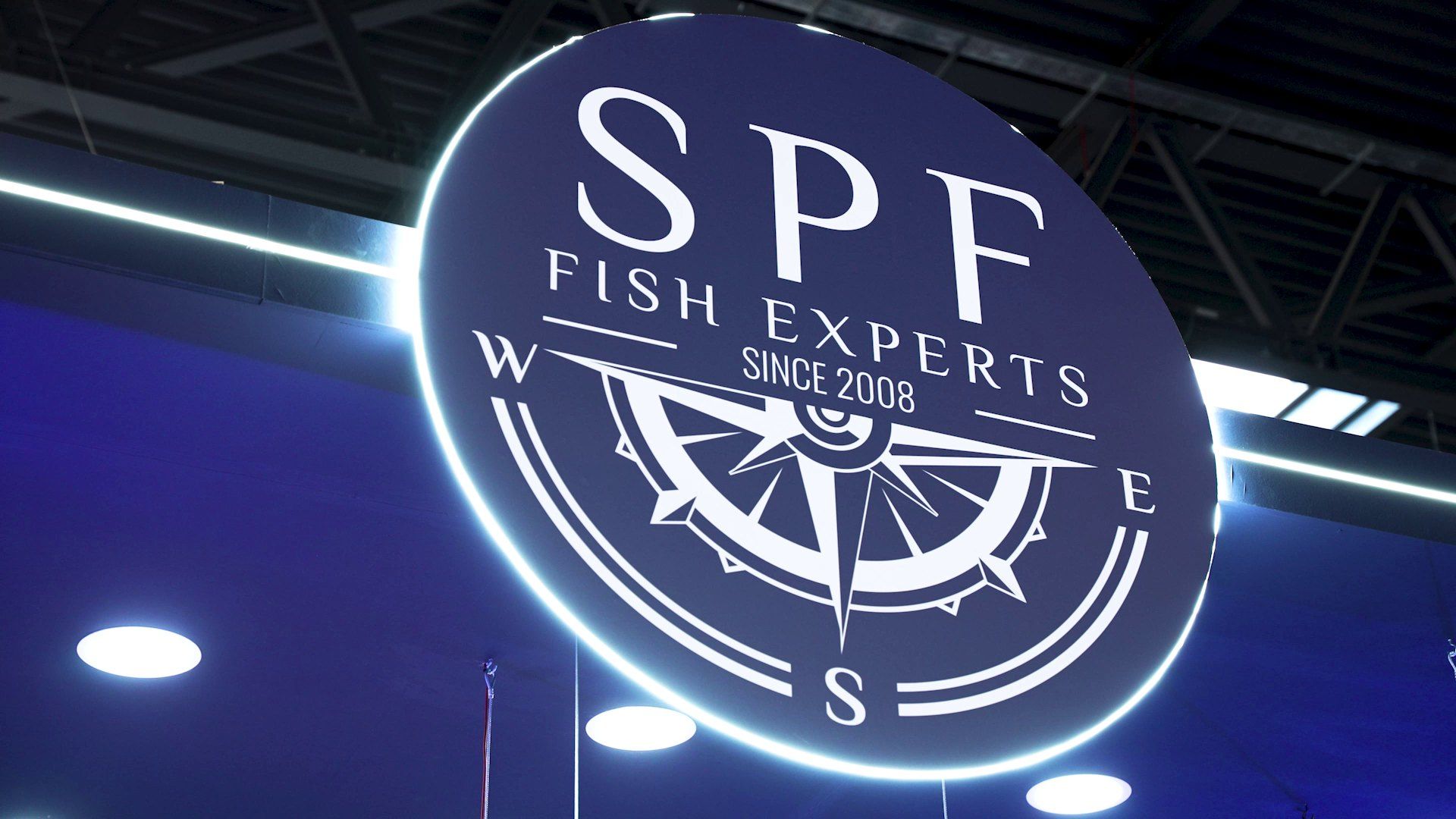 The illuminated SPF Fish Experts logo on its stand
